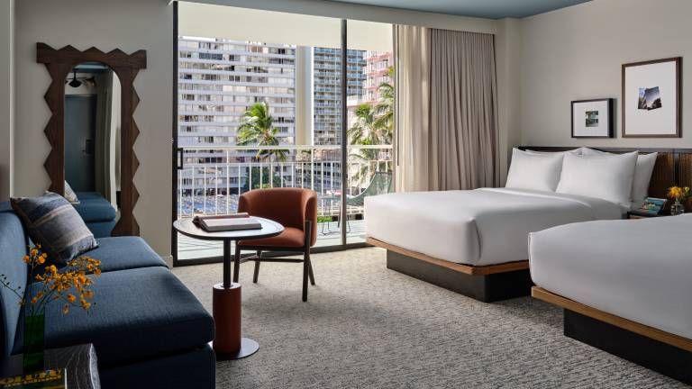 A Luxe Two Queens room comes with a sleeper sofa.