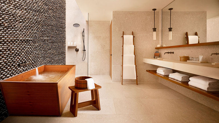 Hand-crafted rock walls and deep wooden soaking tubs are highlights of suite bathrooms.