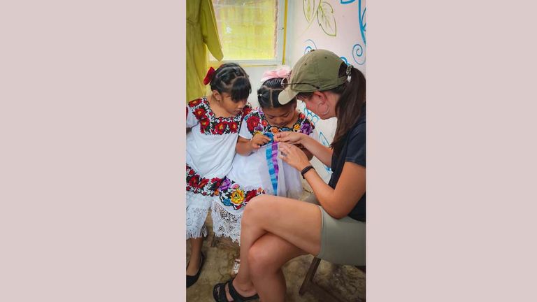 The author learning how to stich at the Lol-Chuy artisan cooperative in X-Pichil, Mexico