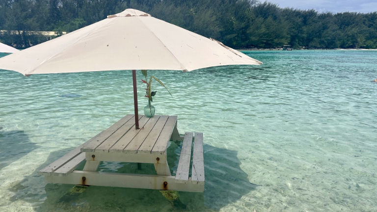 The Fabulous Tour includes lunch at a private motu (small island) where guests eat at tables set directly in the water.