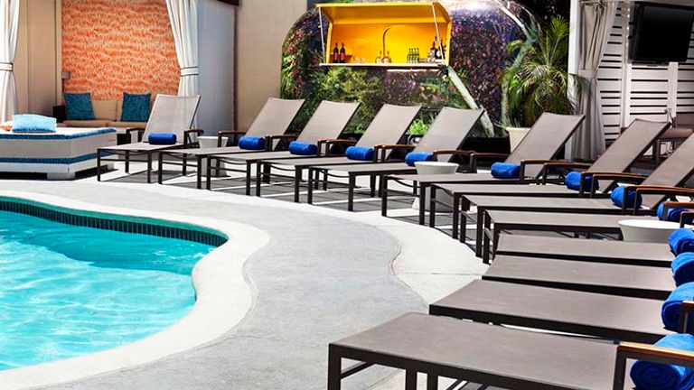 The outdoor pool area features Wet, the hotel’s signature poolside bar. // © 2016 W Hotels